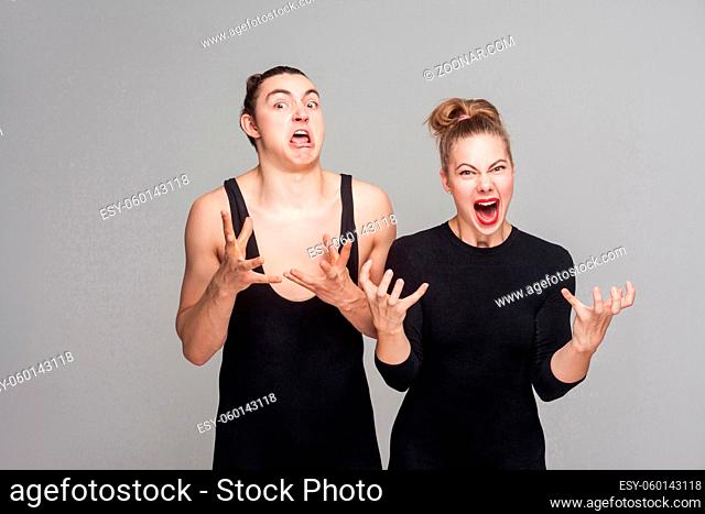 expression unhappy and angry man and woman shout with rage. Studio shot, isolated on gray background