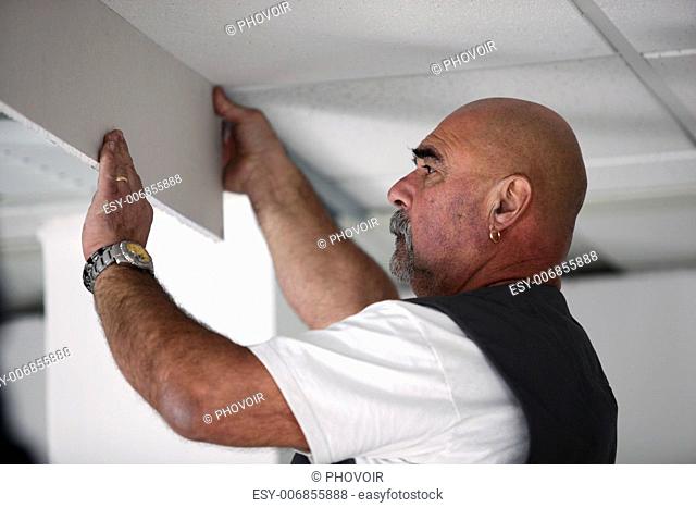 Tradesman installing drywall