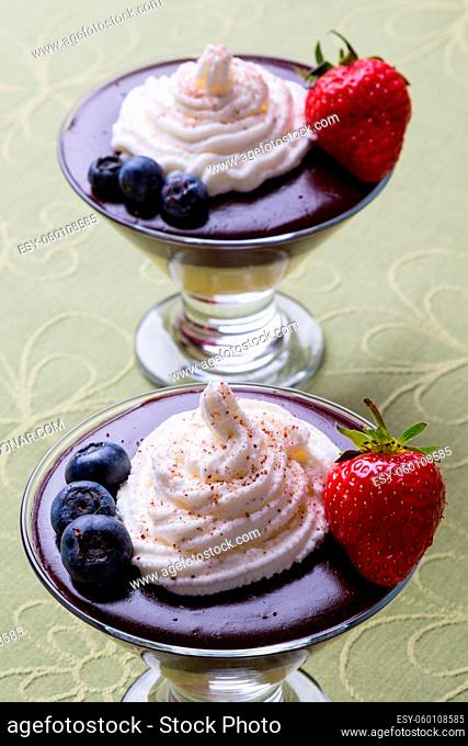 pudding in glass with whipped cream and fruits