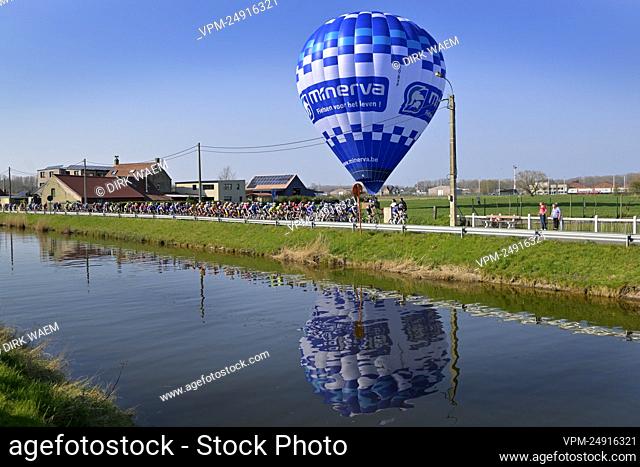 Illustration picture shows the pack of riders passing a hot air balloon of Minerva, during the men's elite race of the 'Classic Brugge-De Panne' one-day cycling...