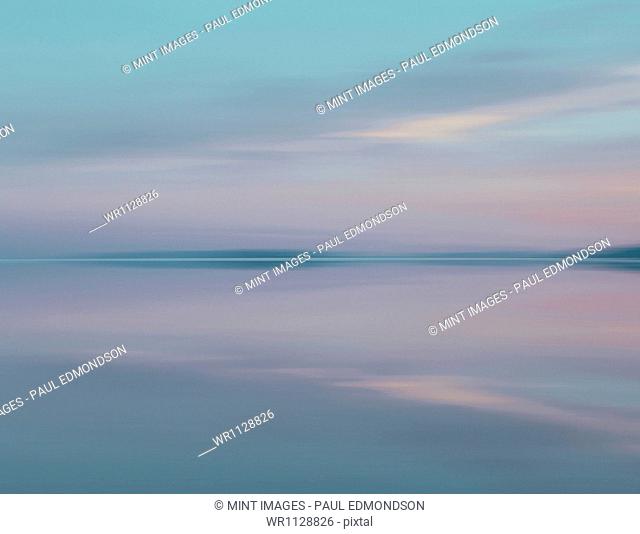 Shallow water over the surface at the Bonneville Salt Flats near Wendover, at dusk. Blurred motion. Pink sunset sky