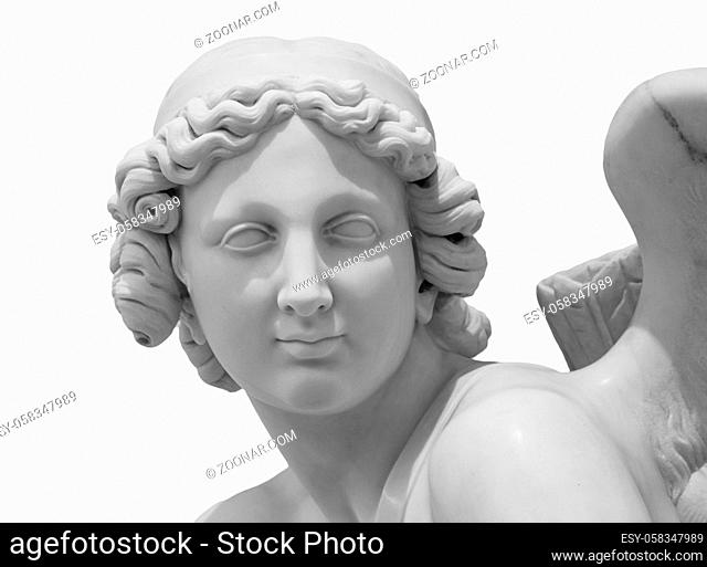Ancient white marble sculpture head of angel. Antique statue isolated on white background. A carved marble cemetery memorial angel