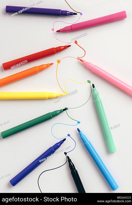 Colorful felt tip pens connected with curved lines