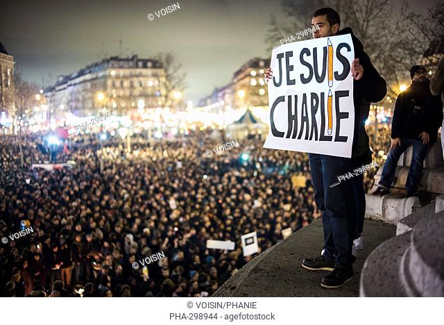People take part in a vigil in Place de la Republique, Paris, France, Wednesday January 7, 2015, after a deadly terror attack on French satirical magazine...