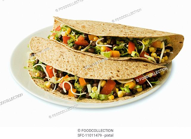 Two Vegetarian Tacos on Multi-Grain Tortillas, White Background