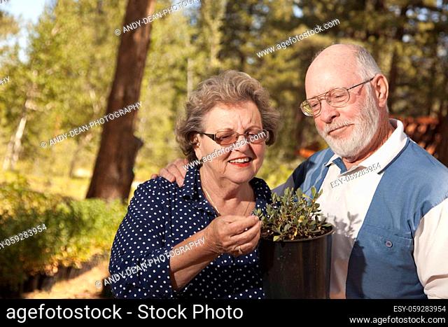 Attractive Senior Couple Overlooking Potted Plants at the Nursery