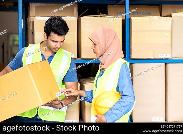 Islam asian warehouse worker working with Indian warehouse worker about inventory and checking on barcode. For business warehouse inventory logistic and...