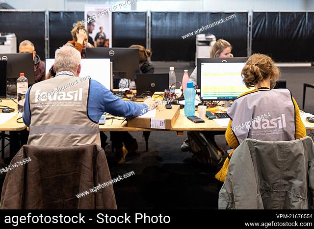 Ukrainians complete their registration at a center for the registration of Ukrainian refugees, at the Palace 8 hall of Brussels expo, Monday 14 March 2022