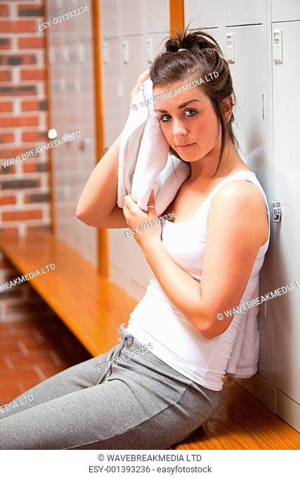Portrait of a sports student drying her head with a towel