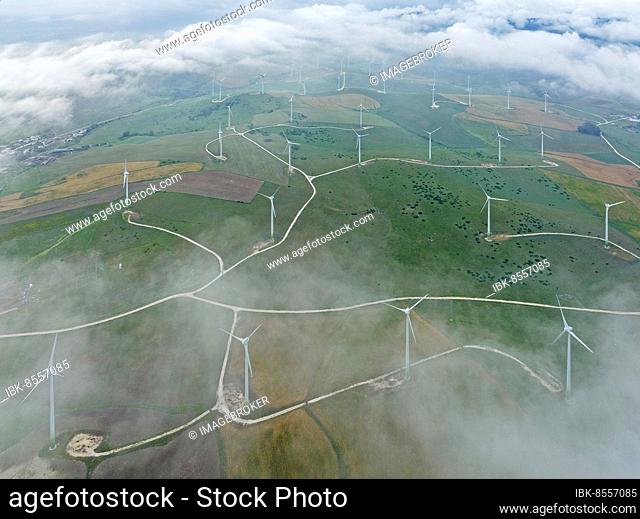 Windmills on a wind farm near Zahara de los Atunes, at a cloudy morning, aerial view, drone shot, Cádiz province, Andalusia, Spain, Europe