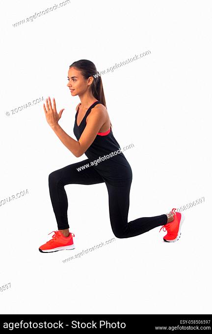 Healthy hispanic fitness girl with doing workout squat exercise isolated on white background