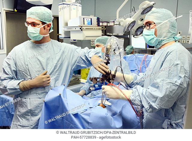 Attendings Mathias Hofer (R-L) and Dirk Lindner perform a surgery on a patient with a brain tumor in an operating room of Leipzig University Hospital's...