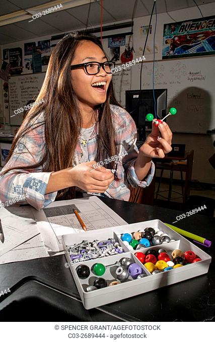 Using plastic molecular component models to illustrate molecular geometry, a San Clemente, CA, high school chemistry student creates an example of Valence Shell...