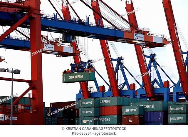 Container are offloaded by bridge like cranes from cargo ships in Hamburg harbor, Germany, Europe