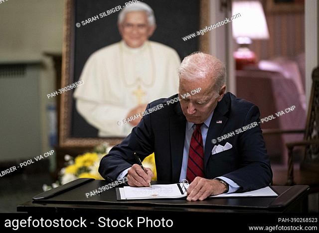 United States President Joe Biden signs the condolence book for Pope Emeritus Benedict XVI at the Apostolic Nunciature of the Holy See in Washington, DC, US