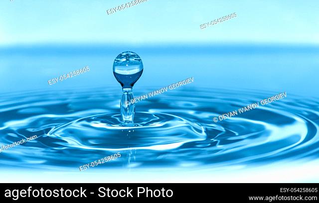 Drop in water. Blue waterdrop macro shot