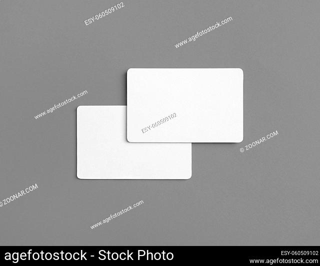Photo of two blank business cards on gray background. Branding ID template. Flat lay