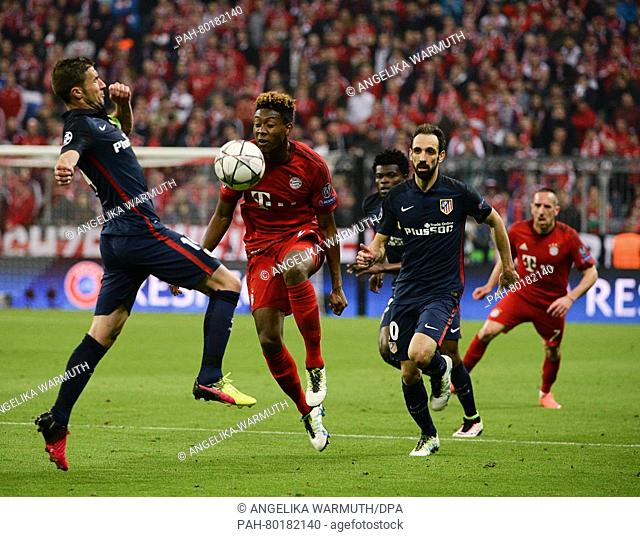 Munich's David Alaba (2-L) in action against Madrid's Gabriel Fernandez (L) and Juanfran Torres during the UEFA Champions League semi final second leg soccer...