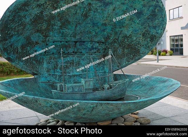 Killybegs, County Donegal, Ireland - June 10, 2017: Fishing boat in open shell as a decoration and welcome sign for tourists in Killybegs, county Donegal