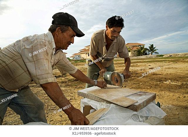 Hopkins, Belize - Workers cut tile for new homes in a resort for wealthy foreigners in a small seaside town in southern Belize  The upscale homes in the Hopkins...