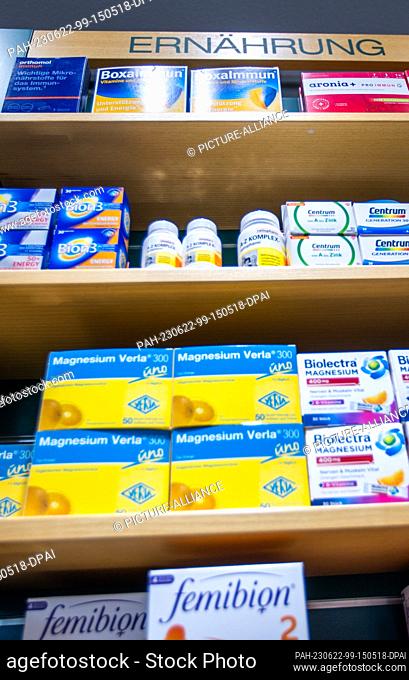 PRODUCTION - 30 May 2023, Mecklenburg-Western Pomerania, Schwerin: Dietary supplements and cosmetics stand on a sales shelf in the Rainbow Pharmacy