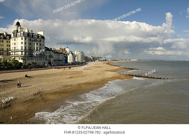 View of shingle beach, promenade and seaside town, Eastbourne, East Sussex, England, april