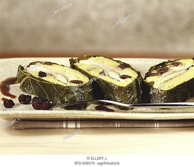 Trout and polenta roll in vine leaves