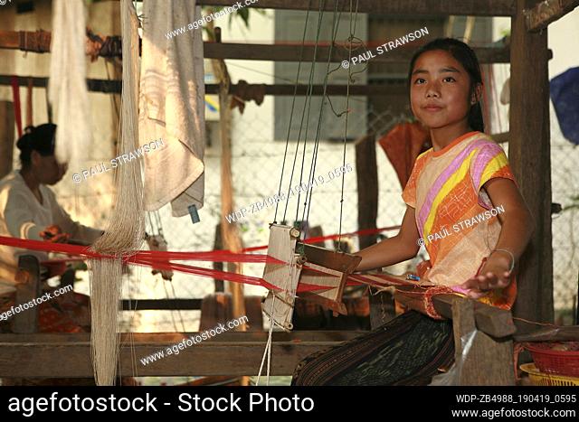 Girl weaving silk on hand loom
