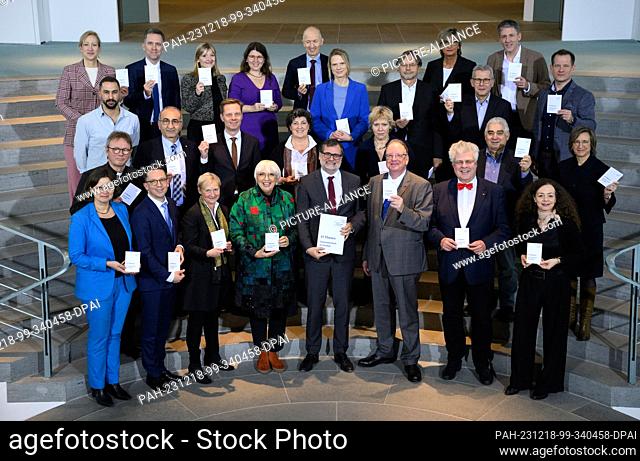 18 December 2023, Berlin: Wolfgang Schmidt (1st row M, SPD), Head of the Federal Chancellery, receives 15 theses on ""Cohesion in Diversity"" from Claudia Roth...