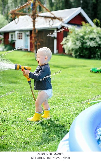 Boy with garden hose