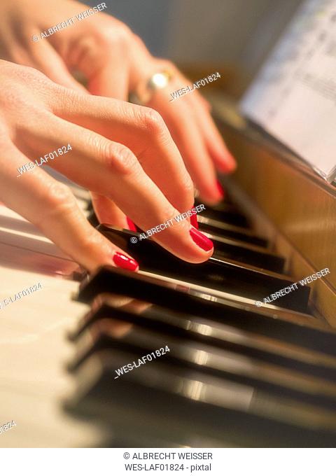 Woman's hands on piano keyboard