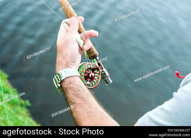 Flyfishing on the lake in Brazil, young fisherman fishing