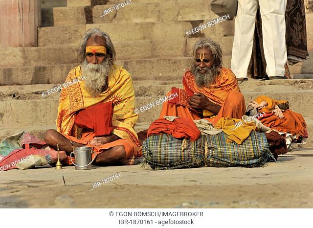 Sadhus on a ghat or steps on the banks of the Ganges in Varanasi, Benares, Uttar Pradesh, India, South Asia