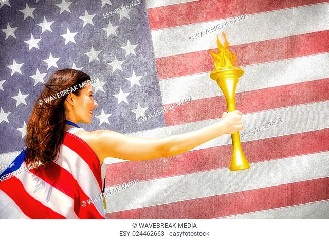 Composite image of rear view of american sportswoman holding a cup