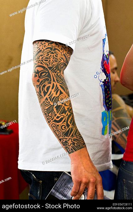 Close up view a man with a tattoo arm