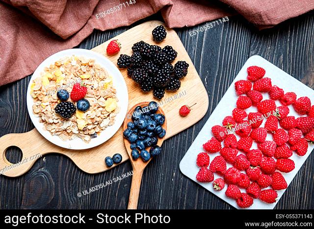 Cereal. Breakfast with muesli and berries. Top view, flat lay