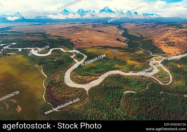 Kurai steppe and Chuya river on North-Chui ridge background. Altai mountains, Russia. Aerial drone panoramic picture
