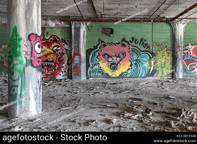 Detroit, Michigan - Graffiti inside the abandoned Fisher Body 21 auto plant. The factory opened in 1919, operated until 1984, and has been abandoned since 1993