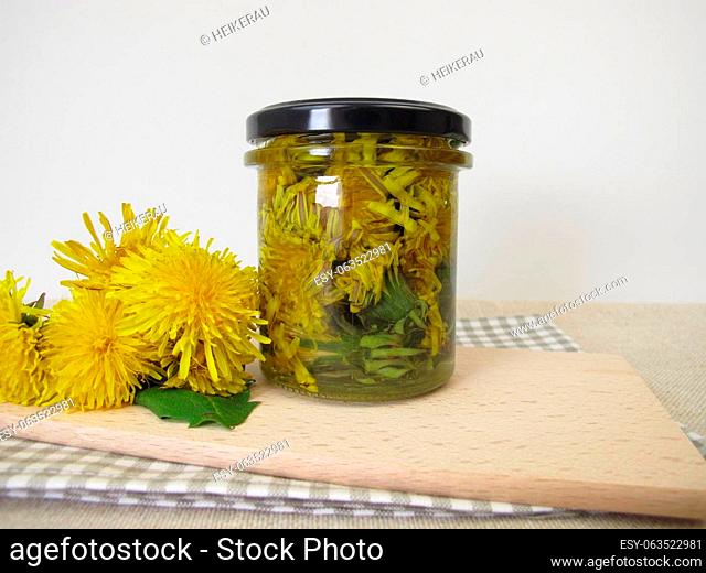Decoction from dandelion flowers in a glass jar