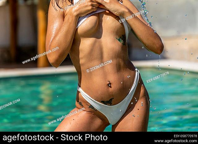 A beautiful young latin model enjoys the summer day at the pool in the Caribbean