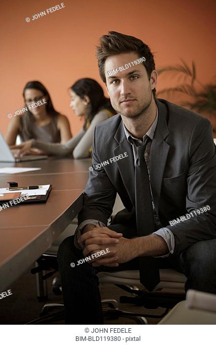 Caucasian businessman sitting at meeting table