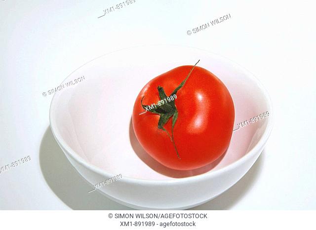 Tomato in white bowl