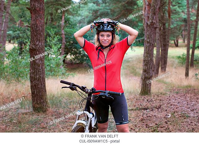 Portrait of woman mountain biker in forest