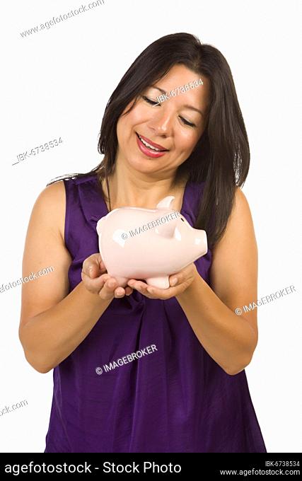 Smiling hispanic woman holding piggy bank isolated on a white background