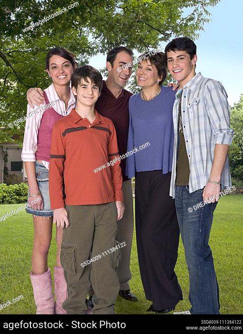 Caucasian family standing in yard