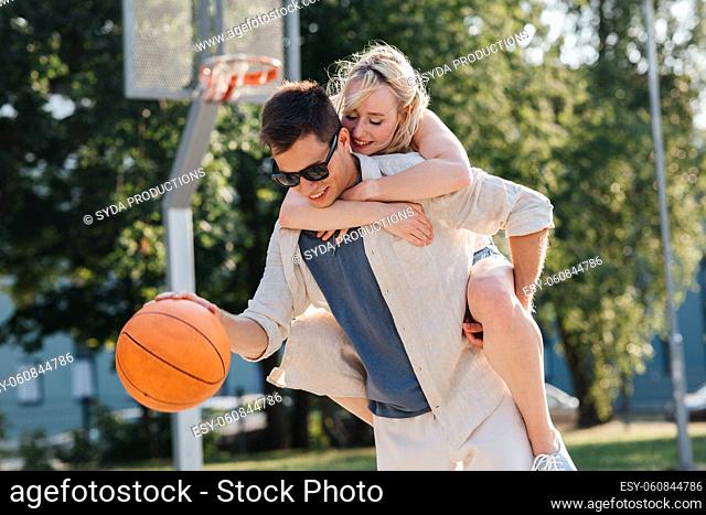happy couple having fun on basketball playground