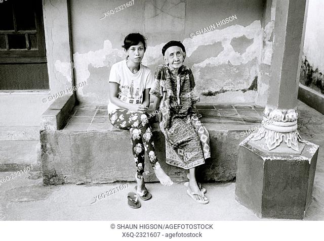 Young woman with her elderly great grandparent in Kota Gede in Yogyakarta in Java in Indonesia in Southeast Asia Far East