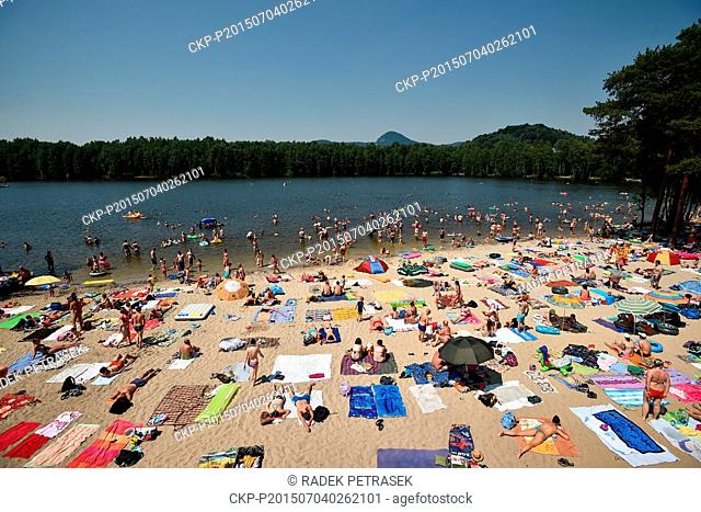 People enjoy a hot sunny day at the outdoor swimming pool Sloup v Cechach, Northern Bohemia, Czech Republic, on Saturday, July 4, 2015