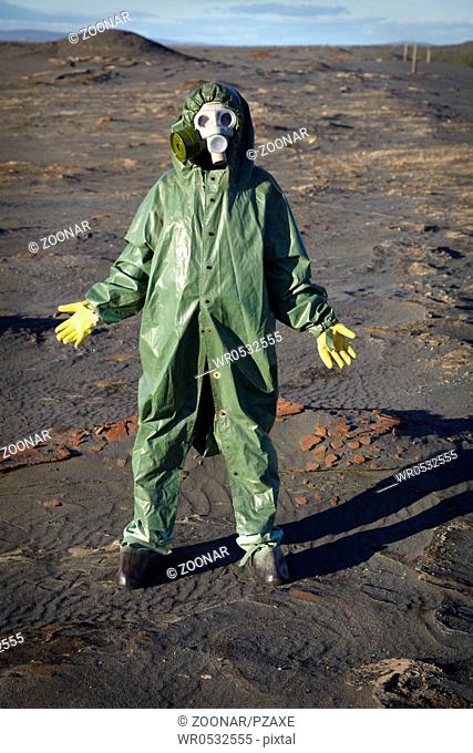 Man in chemical protective suit in desert