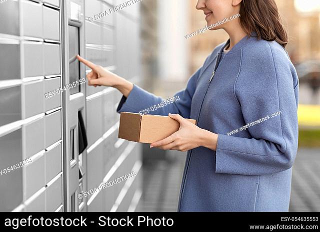 smiling woman with box at automated parcel machine